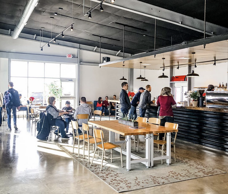 Inside Strata Coffee Bar with customers at the counter